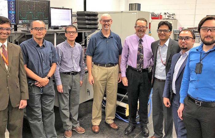 Researchers demonstrated 120 kilowatt wireless power transfer at the National Transportation Research Center, a DOE Office of Science User facility at Oak Ridge National Laboratory. From L-R: ORNL’s Saeed Anwar, Burak Ozpineci, Gui-Jia Su, and David Smith
