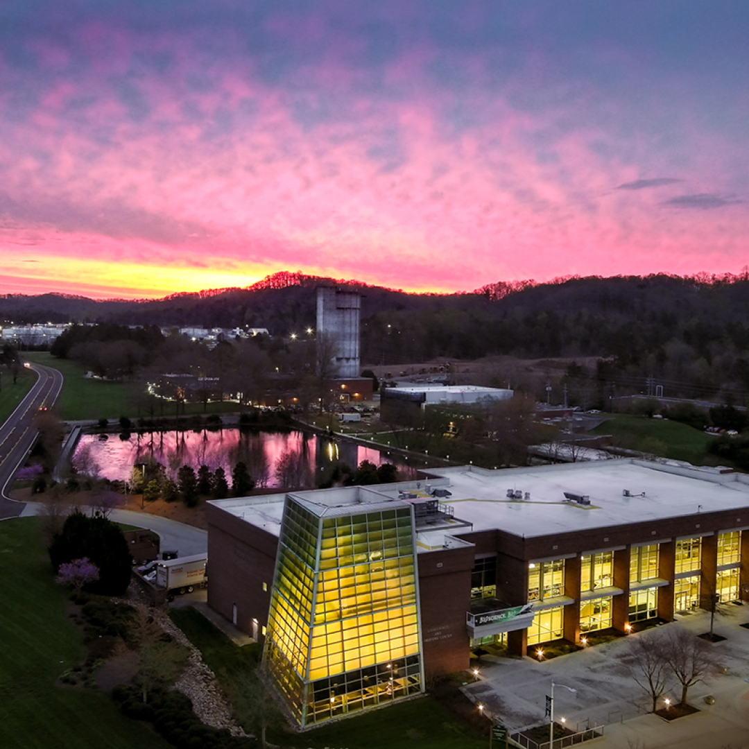 The sun sets behind the ORNL Visitor Center in this aerial photo from April 2023. Credit: Kase Clapp/ORNL, U.S. Dept. of Energy