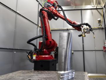 Wire arc additive manufacturing allowed this robot arm at ORNL to transform metal wire into a complete steam turbine blade like those used in power plants. Credit: Carlos Jones/ORNL, U.S. Dept. of Energy