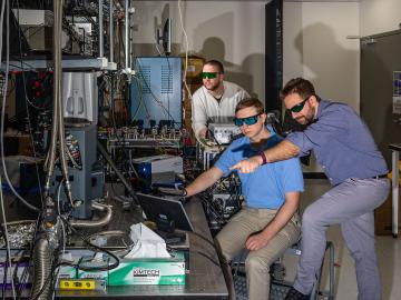 From left, J.D. Rice, Trevor Michelson and Chris Seck look at a monitor in Seck’s lab. The three are wearing safety glasses to protect against the laser beams used by the scanning vibrometer, which is helping Seck quantify vibration of an appliance in his lab. Carlos Jones/ORNL, U.S. Dept. of Energy