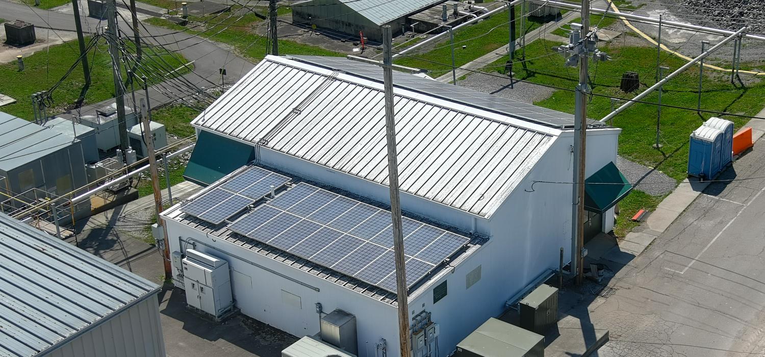 overhead shot of DECC lab building with power poles around it and solar panels on roof