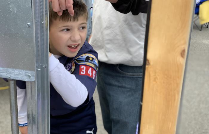 Liam Robinson, 7, from Knoxville Cub Scout Pack 346, checked out a display of home electrical wiring and picked up a pair of high-voltage-rated channel locks at the Facilities & Operations exhibit staffed by electrician Jonathan Crowley. “He was picking up stuff … and loving every bit of it,” said Liam’s father, Will Robinson.