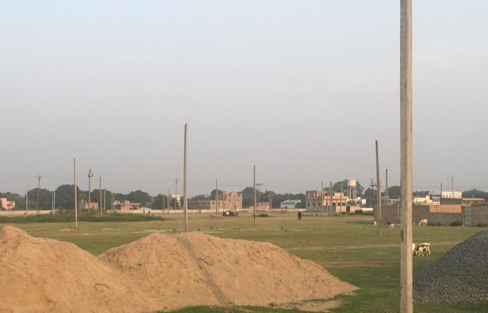 A patch of urban land with utility poles waits to be electrified in Samastipur, Bihar, India. Credit: Bhartendu Pandey