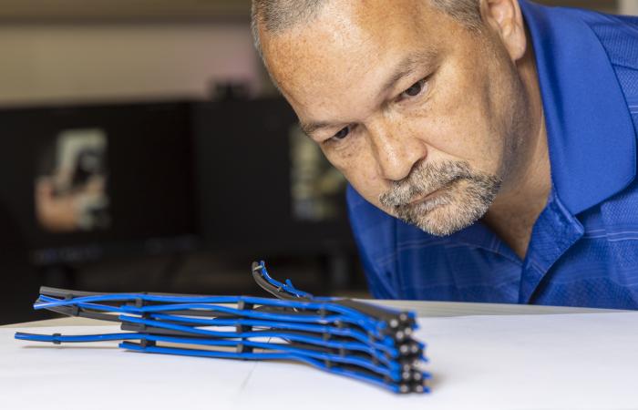 Mark Roberts looks at cable separator he created
