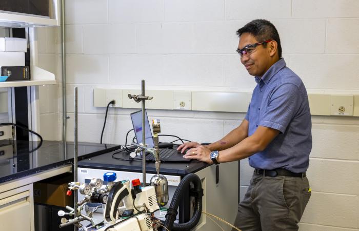 Christian Salvador is studying natural and manmade aerosols at Oak Ridge National Laboratory to improve our understanding of how atmospheric pollutants affect ecosystems and the Earth’s climate. Credit: Carlos Jones/ORNL, U.S. Dept. of Energy