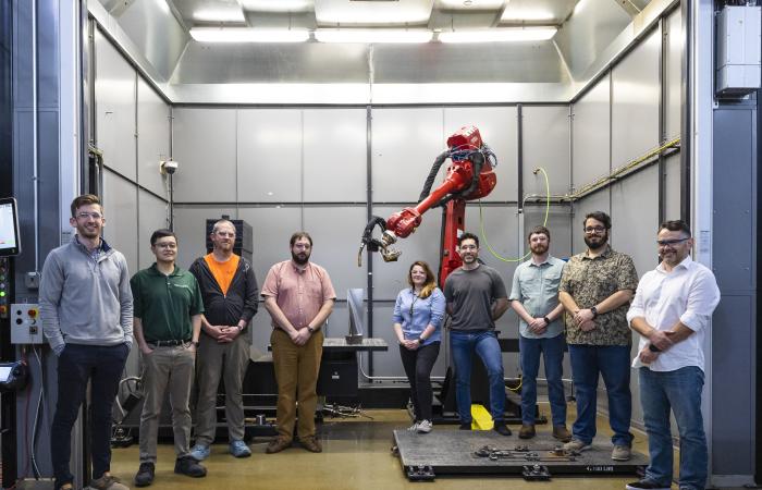 The ORNL team worked with industry partner Siemens to create a steam turbine blade, shown at the center of the image, using a wire arc 3D printer in DOE’s Manufacturing Demonstration Facility. Credit: Carlos Jones/ORNL, U.S. Dept. of Energy