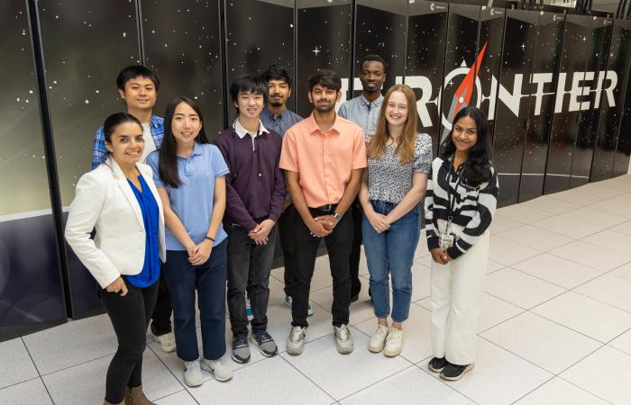 PCIP students work with mentors on computing projects in domains ranging from astrophysics to AI. From left are System Acceptance and User Environment group leader Verónica Melesse Vergara, Kevin Peng, Hannah Bao, Matthew Tan, Prabhash G C, Dhanvi Bharadwaj, HPC Engineer Elijah MacCarthy, Emma Bohse, and Aninditha Nair. Credit: ORNL, U.S. Dept. of Energy