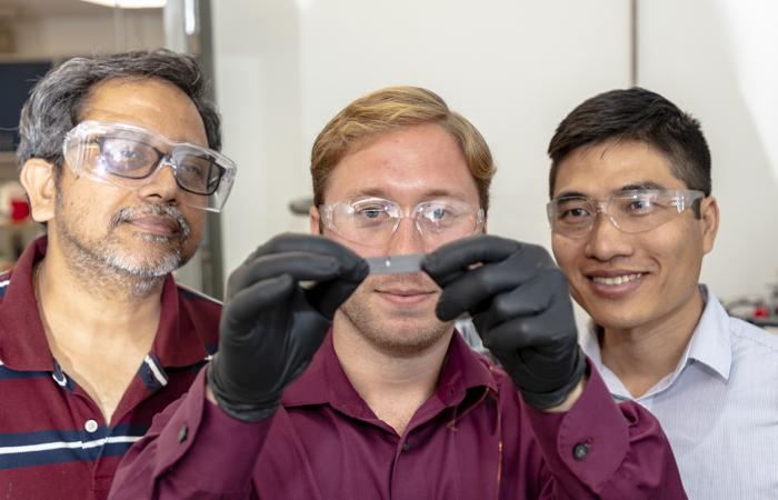 From left, Naskar, Bowland and Nguyen examined a cantilever made of fiber-reinforced composite with the fibers aligned in one direction and measured its electrical resistance in response to stress. Credit: Carlos Jones/Oak Ridge National Laboratory, U.S. 