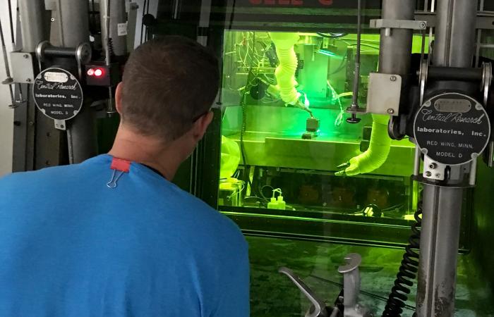 ORNL and EPRI built an enclosed welding system in a hot cell of ORNL’s Radiochemical Engineering Development Center. C. Scott White (ORNL) performs operations with remotely controlled manipulators and cameras. 