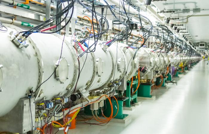 At SNS’s Beamline 13, protons hit a target of mercury, an atom with a big nucleus capable of releasing a slew of energetic particles. These particles enter a moderator that decreases their energies. Some of the particles, called pions, are charged and lig