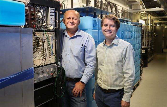 From left, Jason Newby of ORNL and Yuri Efremenko of the University of Tennessee–Knoxville/ORNL check equipment for the COHERENT experiment at the SNS. In 2005 Efremenko and others proposed a neutrino facility at the SNS; that vision is realized in the cu