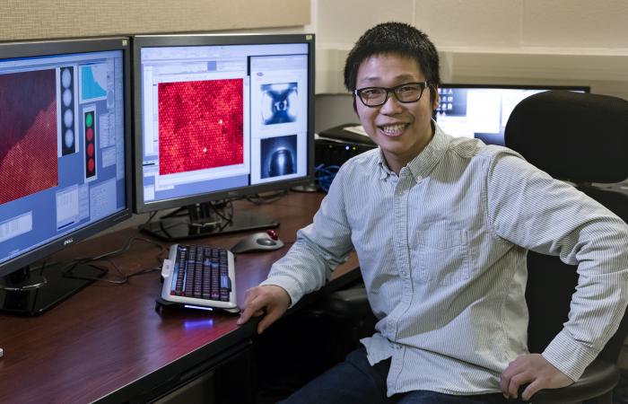 ORNL’s Xiahan Sang unambiguously resolved the atomic structure of MXene, a 2D material promising for energy storage, catalysis and electronic conductivity. Image credit: Oak Ridge National Laboratory, U.S. Dept. of Energy; photographer Carlos Jones