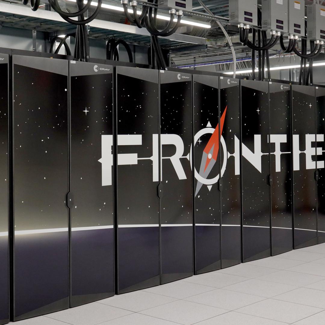 Photo of the front row of the Frontier supercomputer showing the Frontier logo. 