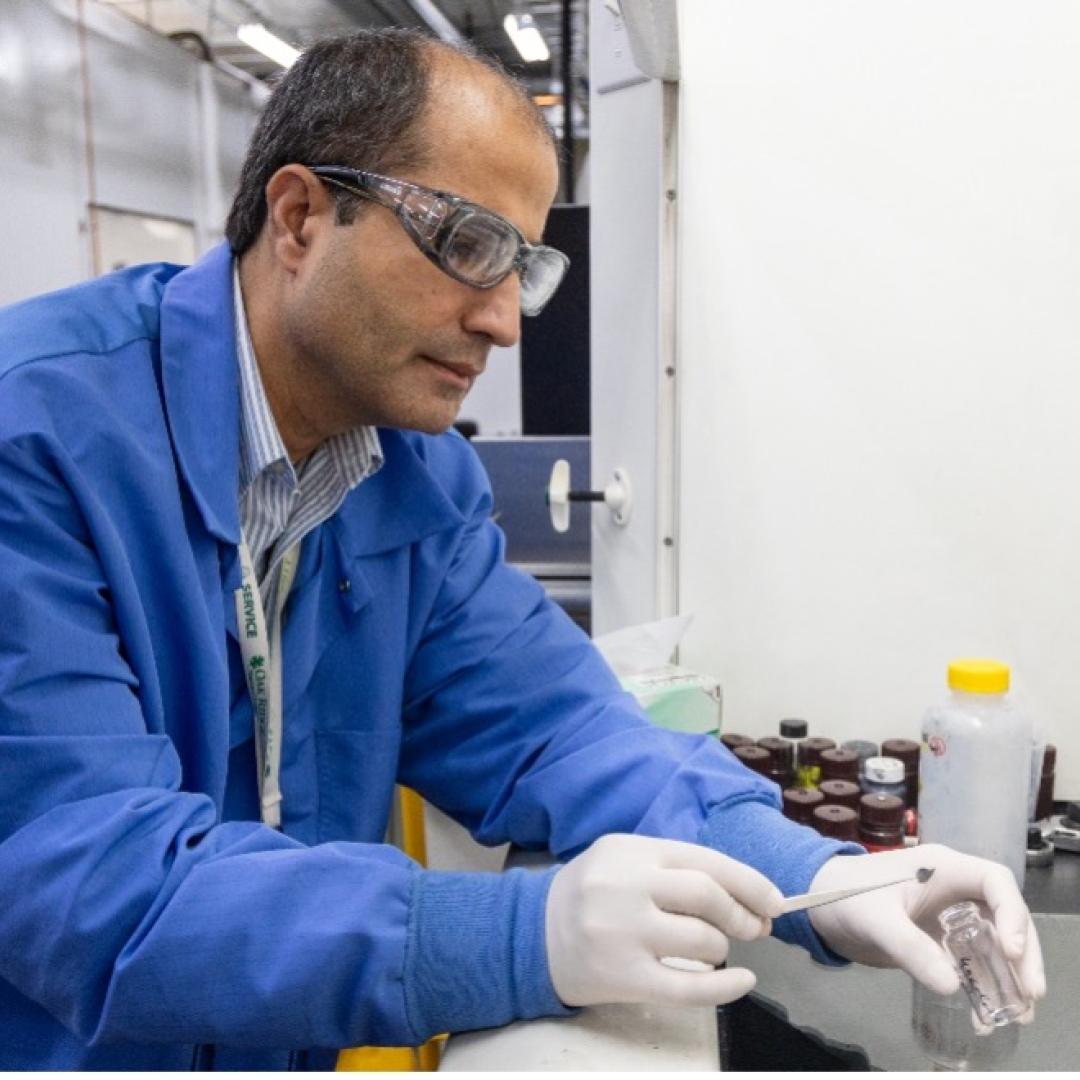 Caption: Jaswinder Sharma makes battery coin cells with a lightweight current collector made of thin layers of aligned carbon fibers in a polymer with carbon nanotubes. Credit: Genevieve Martin/ORNL, U.S. Dept. of Energy