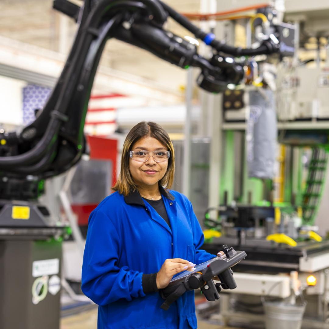 Researcher Brittany Rodriguez works with an ORNL-developed Additive Manufacturing/Compression Molding system that 3D prints large-scale, high-volume parts made from lightweight composites. Credit: Carlos Jones/ORNL, U.S. Dept. of Energy