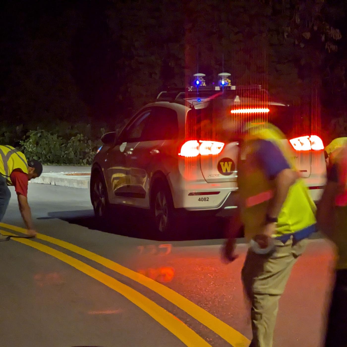 Researchers from ORNL and Western Michigan University prepare for a Chattanooga-based demonstration of a self-driving car using chip-enabled raised pavement markers for navigation.