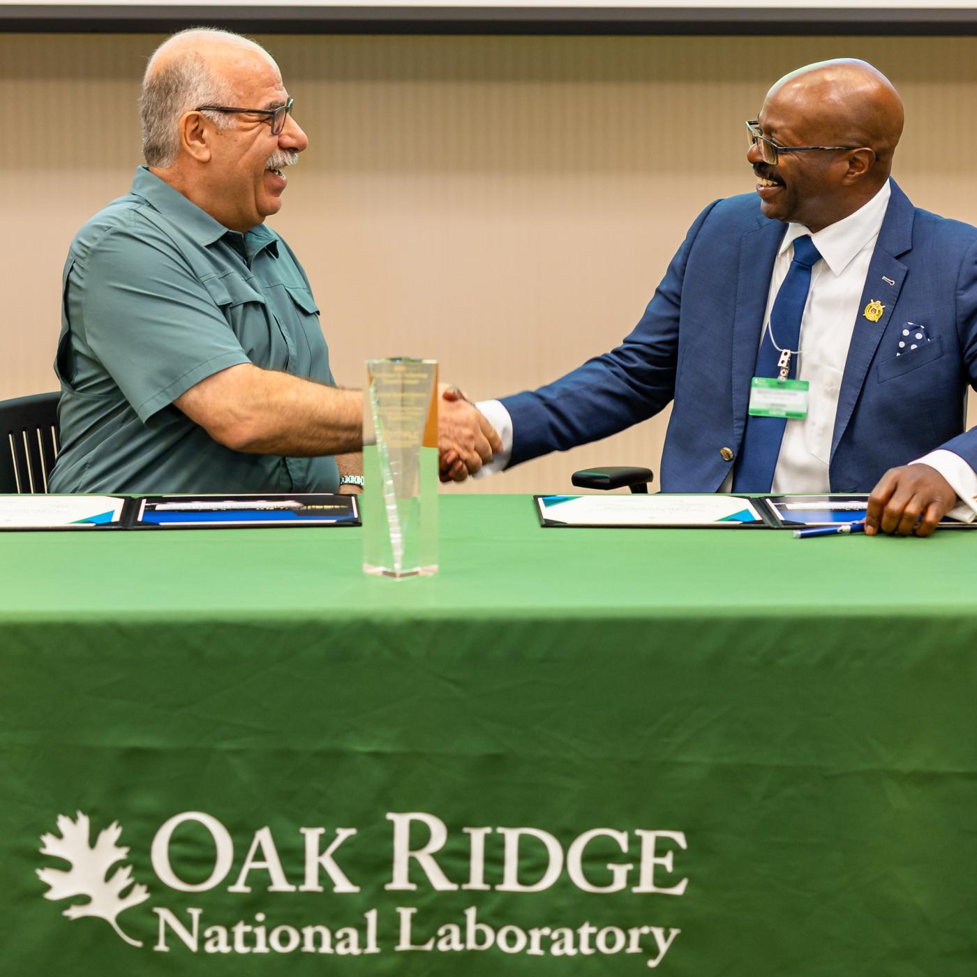 Moe Khaleel, left, associate laboratory director for national security sciences, and Maurice Singleton, chief executive officer of U2opia Technology, celebrate the partnership between Oak Ridge National Laboratory and U2opia Technology. Credit: Carlos Jones/ORNL, U.S. Dept. of Energy