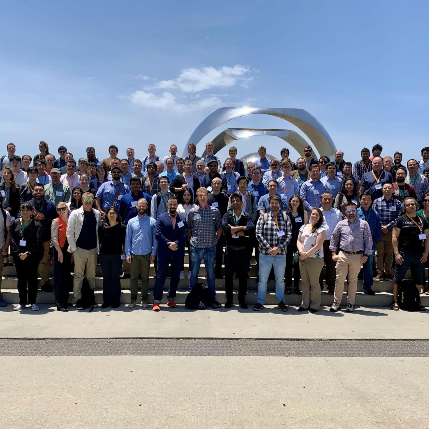 Large group photo outside on stairs at the Quantum Science Center all hands meeting.