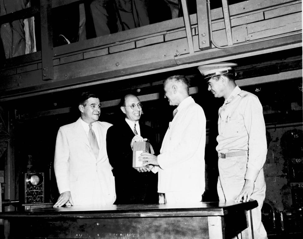 Eugene Wigner hands first shipment of radioisotopes to A.U. Cowdry, Director of Barnard Free Skin and Cancer Hospital, St. Louis, Missouri, August 1946.