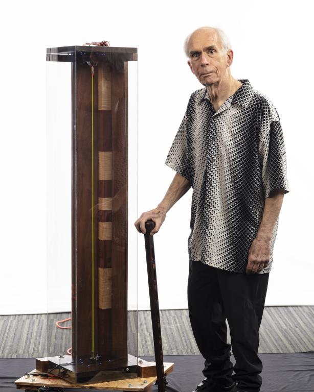 Retired ORNL Distinguished Staff Member Duane Starr stands with the critical frequencies demo unit he designed, built and donated to the la to visually demonstrate the critical inflection points of a gas centrifuge. Credit: Carlos Jones/ORNL, U.S. Dept. of Energy
