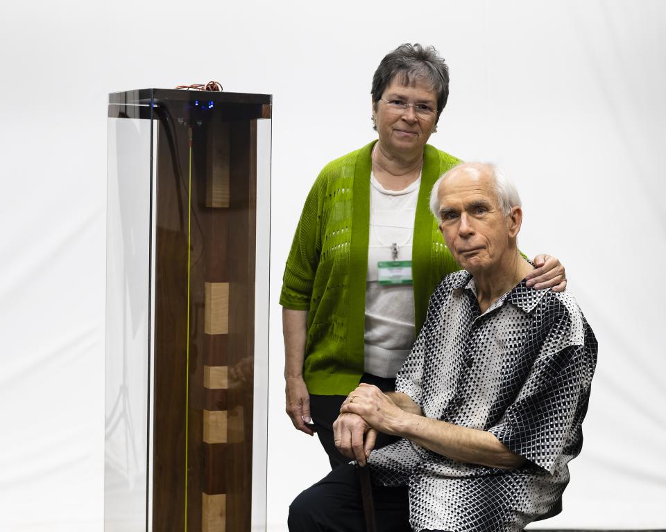 ORNL retiree Duane Starr and his wife, Nancy, pose with the critical frequencies demo unit Duane designed, built and donated to the laboratory to support nuclear workshops.  Credit: Carlos Jones/ORNL, Dept. of Energy