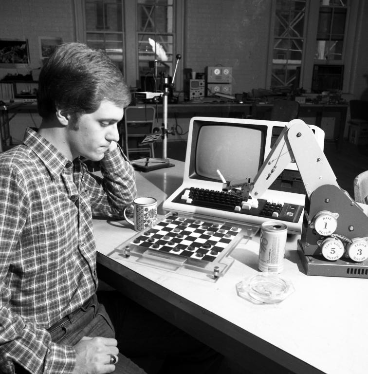 A researcher plays checkers against an AI-powered robotic arm in 1984. Credit: ORNL, U.S. Dept. of Energy