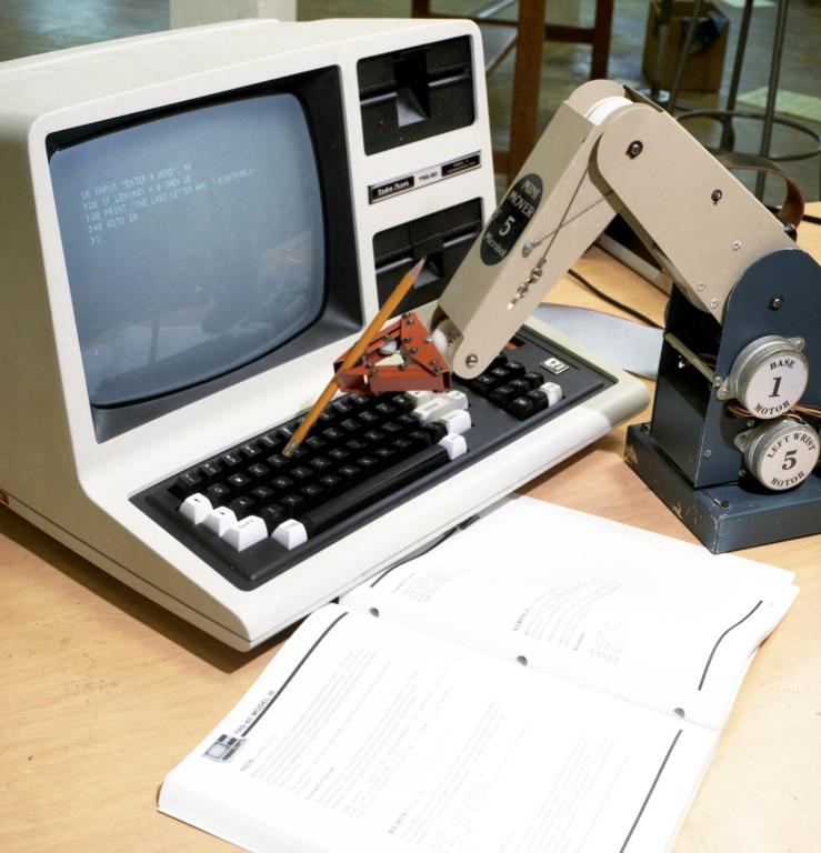 A computer is typing on its own keyboard using a programmed robotic arm. Credit: ORNL, U.S. Dept. of Energy. 