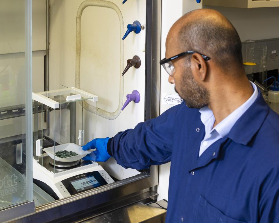 ORNL’s Syed Islam weighs nickel sulfate recovered from end-of-life lithium-ion batteries to determine the yield and efficiency of the critical material recovery process.  Carlos Jones/ORNL, U.S. Dept. of Energy