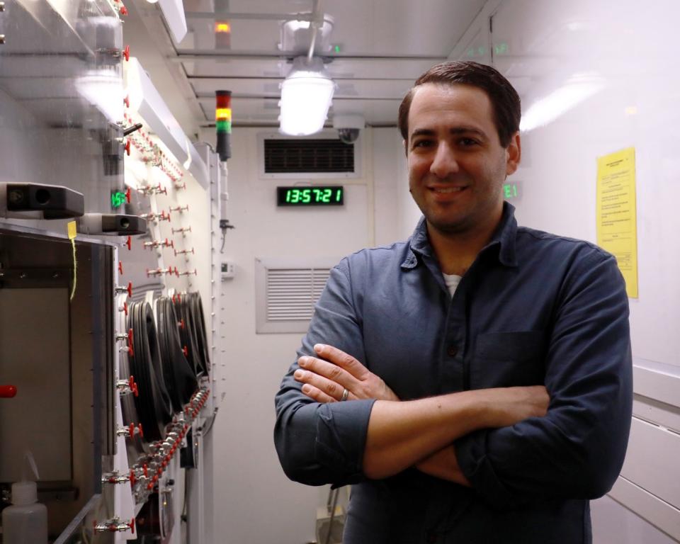 Domenick Leto poses near assessment equipment for nuclear materials. Credit: Lena Shoemaker/ORNL, U.S. Dept. of Energy