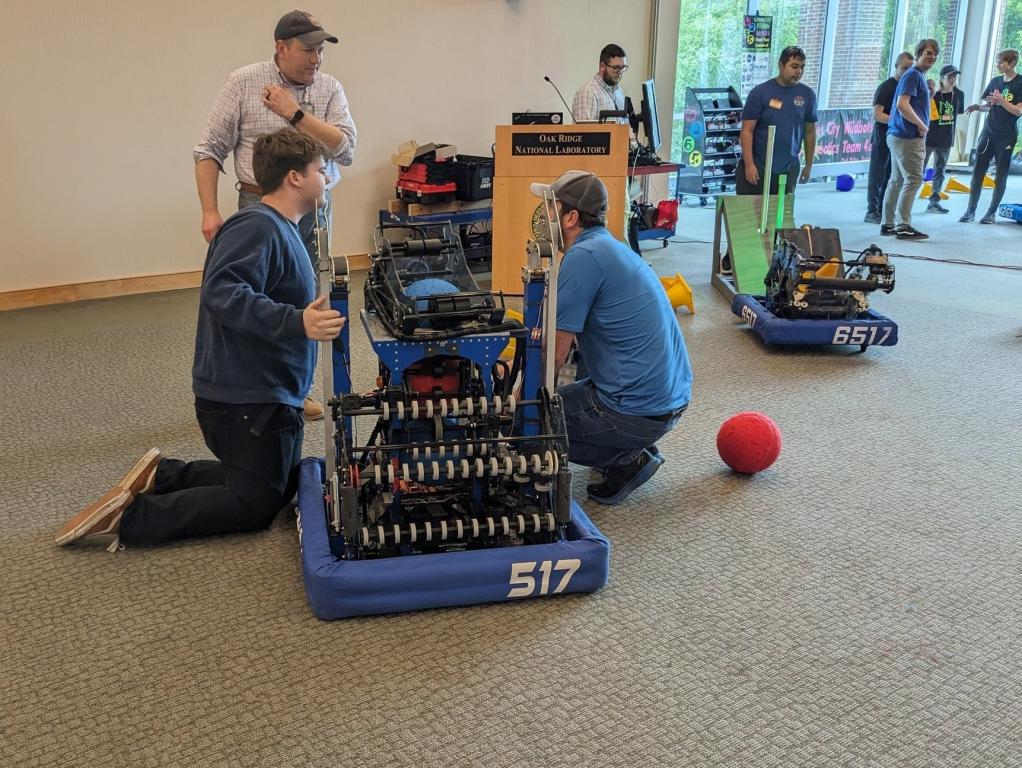 Noah Miller, back right, assists South-Doyle High School First Robotics Club members with a demonstration at ORNL’s 2023 Take Your Child to Work Day.