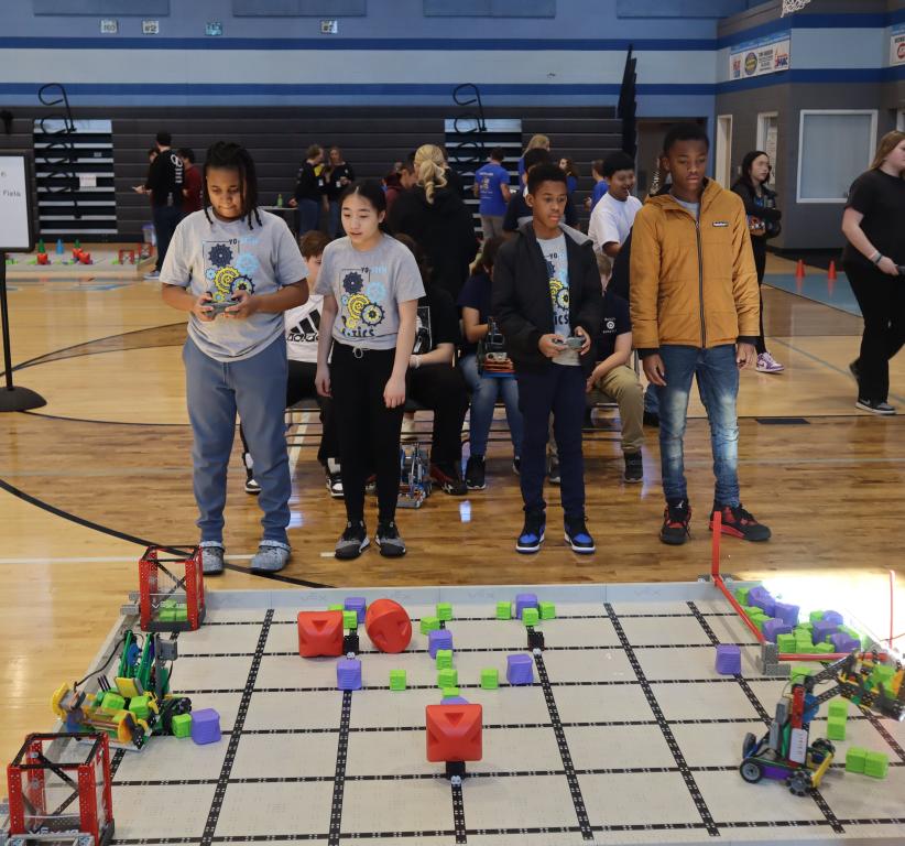 YO STEM kids showing their robots
