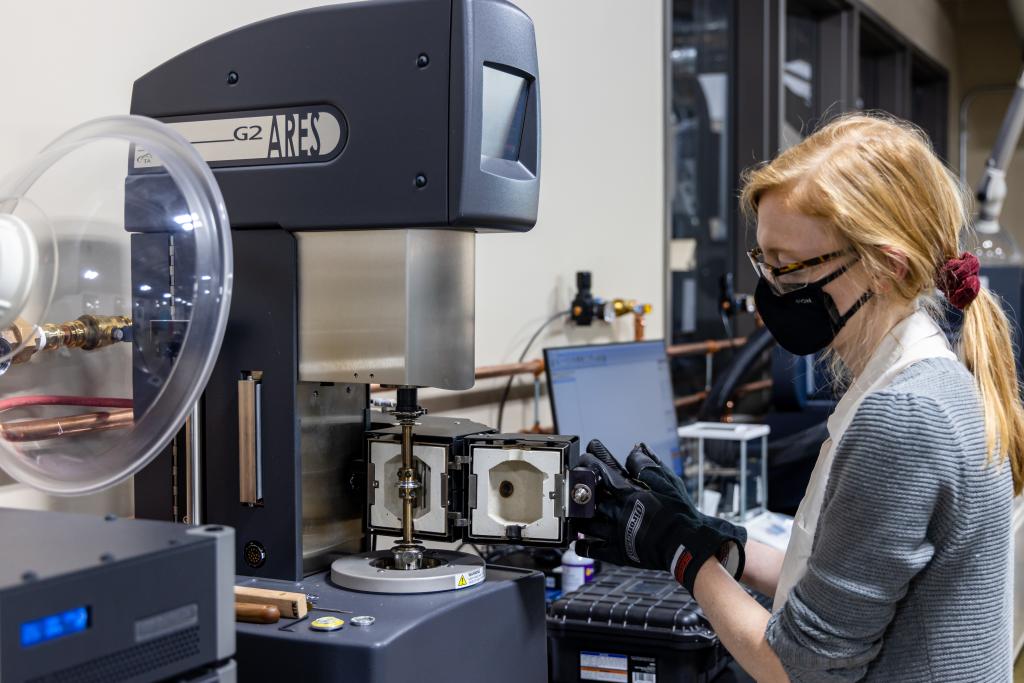 researcher in front of machine