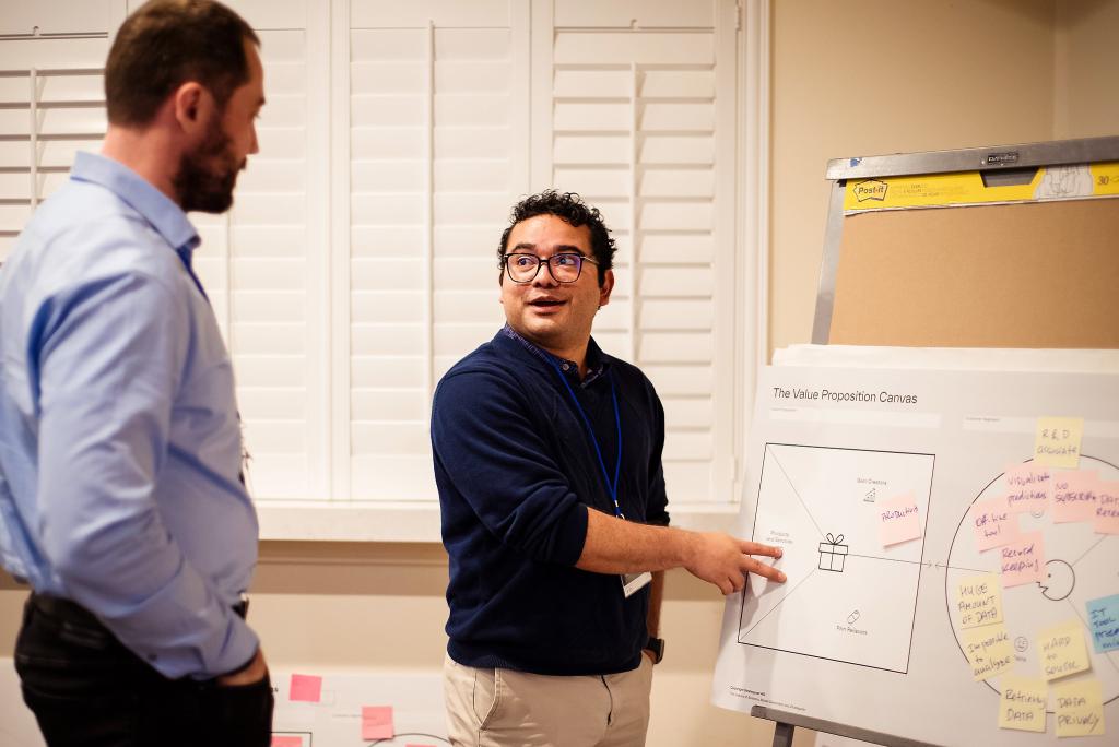 Dmytro Bykov, left, and Hector Corzo participate in a value proposition development exercise as part Energy I-Corps