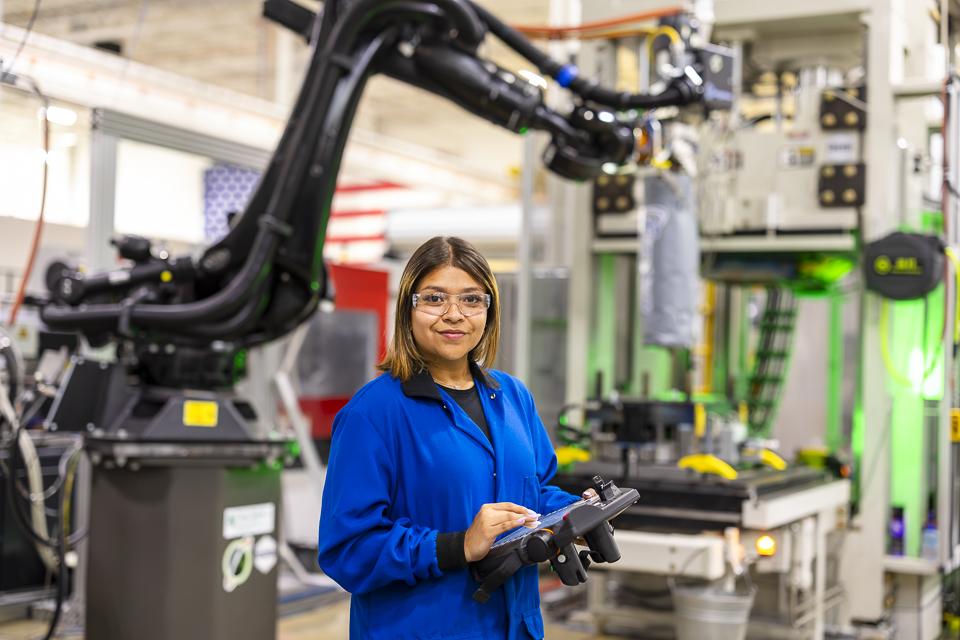 Researcher Brittany Rodriguez works with an ORNL-developed Additive Manufacturing/Compression Molding system that 3D prints large-scale, high-volume parts made from lightweight composites. Credit: Carlos Jones/ORNL, U.S. Dept. of Energy