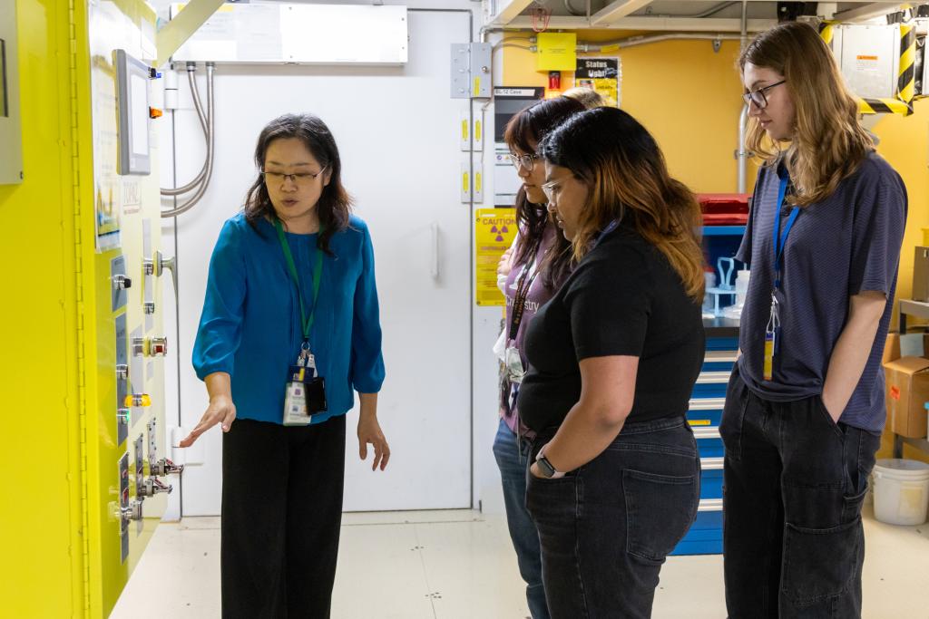 Students listen as ORNL instrument scientist Hanyu Wang explains the intricacies of the LIQREF instrument at the Spallation Neutron Source