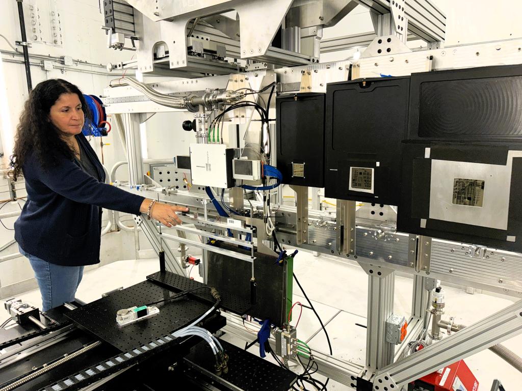 ORNL neutron scattering scientist Hassina Bilheux points to equipment inside VENUS. 