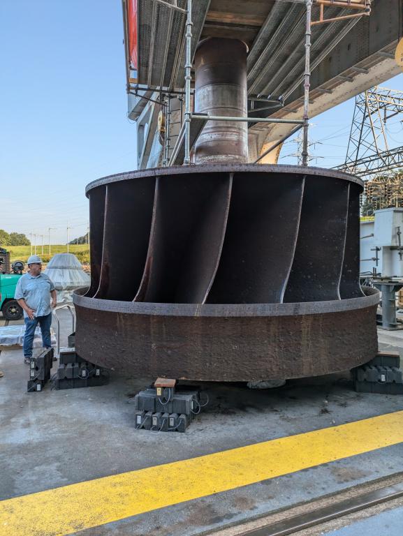 Jay Tiley inspects a hydroelectric runner from TVA’s Cherokee Dam