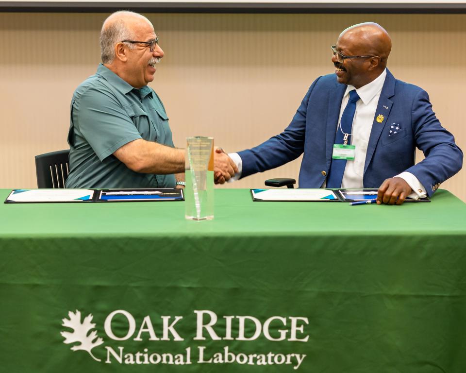 Moe Khaleel, left, associate laboratory director for national security sciences, and Maurice Singleton, chief executive officer of U2opia Technology, celebrate the partnership between Oak Ridge National Laboratory and U2opia Technology. Credit: Carlos Jones/ORNL, U.S. Dept. of Energy