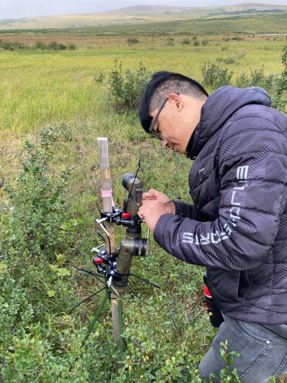 Daryl Yang works with a camera that gathers multispectral data to analyze vegetation changes in Alaska. Credit: Shawn Serbin/Brookhaven National Laboratory, U.S. Dept. of Energy