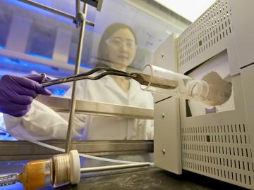 ORNL’s Huiyuan Zhu places a sample of boron nitride, or “white graphene,” into a furnace as part of a novel, nontoxic gas exfoliation process to separate 2D nanomaterials. ORNL’s Huiyuan Zhu places a sample of boron nitride, or “white graphene,” into a furnace as part of a novel, nontoxic gas exfoliation process to separate 2D nanomaterials.