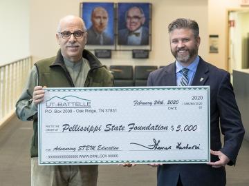 Moe Khaleel (left), associate laboratory director of ORNL’s Energy and Environmental Sciences Directorate, presents a symbolic check to Pellissippi State Community College President L. Anthony Wise Jr.
