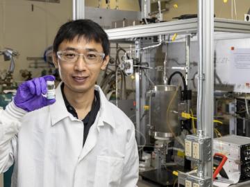 Zhenglong Li, an ORNL scientist in the Energy and Transportation Science Division, holds a sample of a catalyst material used to covert ethanol into butene-rich mixed olefins, important intermediates that can then be readily processed into aviation fuels. Credit: Carlos Jones/ORNL, U.S. Dept. of Energy 