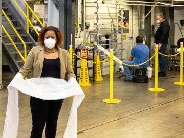 Merlin Theodore holding N95 mask filtration material produced at DOE's Carbon Fiber Technology Facility