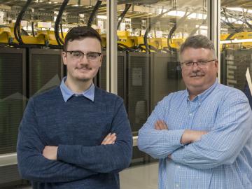 Tyler Duckworth, left, poses with his father, Robert Duckworth, in front of the Summit supercomputer. Tyler Duckworth has been named recipient of the 2021 UT-Battelle Scholarship to attend the University of Tennessee. Credit: Carlos Jones/ORNL, U.S. Dept. of Energy
