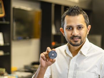 Shajjad Chowdhury, an ORNL power electronics researcher, is designing a more compact and power-dense capacitor that will help maximize electric vehicle driving range. Credit: Carlos Jones/ORNL, U.S. Dept. of Energy