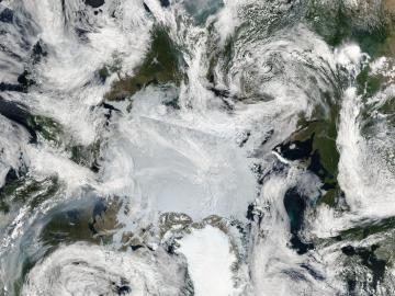 Clouds of gray smoke in the lower left are funneled northward from wildfires in Western Canada, reaching the edge of the sea ice covering the Arctic Ocean. A second path of thick smoke is visible at the top center of the image, emanating from wildfires in the boreal areas of Russia’s Far East, in this image captured on July 13, 2023. Credit: NASA MODIS