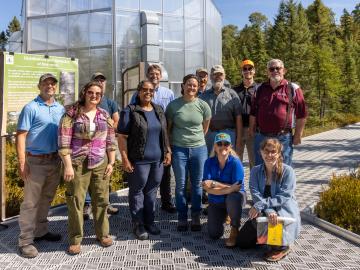 Front row: Victoria DiStefano and Dr. Asmeret Asefaw Berhe of DOE toured the SPRUCE experiment with Natalie Griffiths, Melanie Mayes, and Verity Salmon; back row: Dave Weston, Stephen Sebestyen (US Forest Service), Jonathan Stelling, Mark Guilliams, John Latimer (ORNL contractor), Kyle Pearson and Paul Hanson. Credit: Genevieve Martin/ORNL, U.S. Dept. of Energy