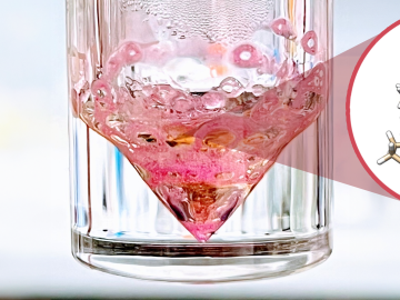 Pink diamond shape in a glass jar. There is a cut out showing the chemical makeup of what's inside.