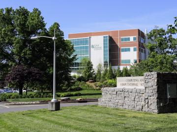 Oak Ridge National Laboratory building and sign for the Computing and Computational Sciences Directorate.