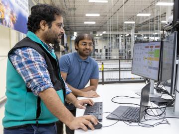 ORNL researchers Phani Marthi and Suman Debnath work on developing and scaling up new EMT simulation software to analyze how power electronics in the electric grid will respond to brief interruptions in power flow. Credit: Genevieve Martin/ORNL, U.S. Dept. of Energy